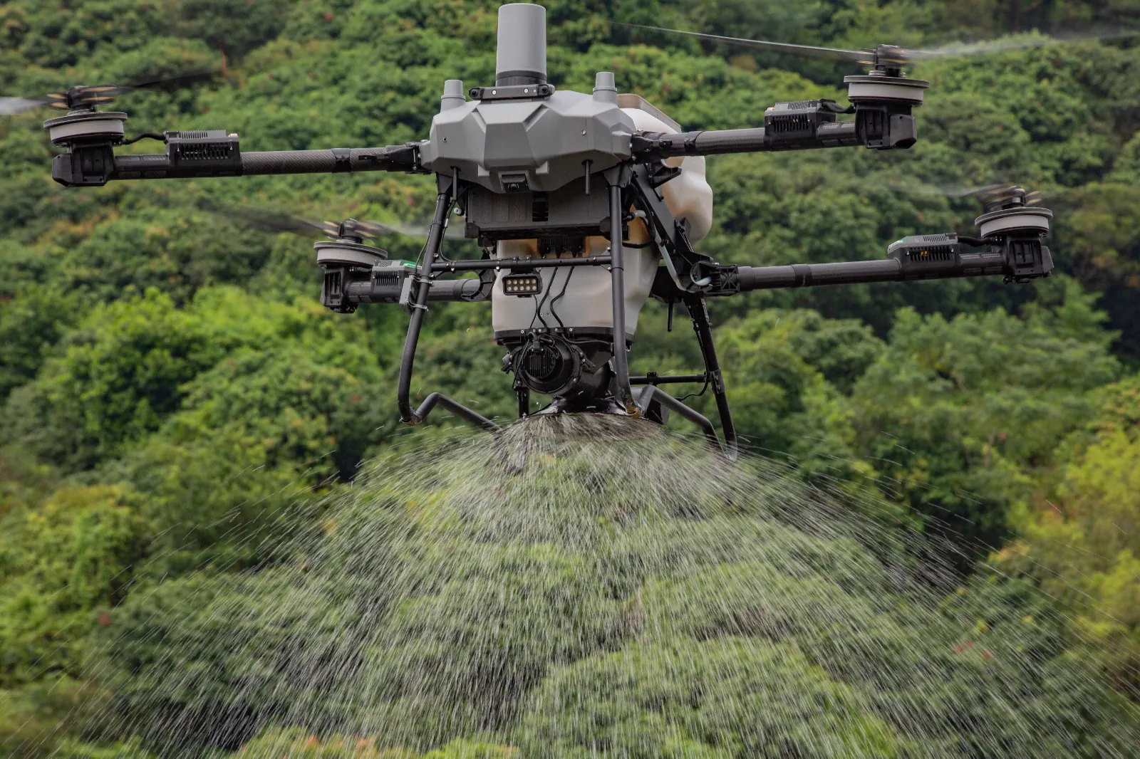 DJI Agras T100 spreading over trees